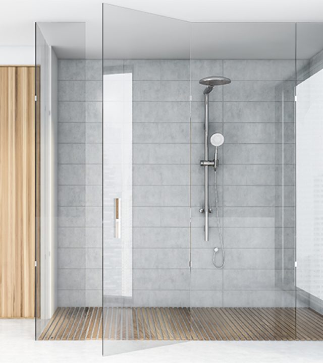 Interior of spacious bathroom with white tile walls, concrete floor, comfortable shower stall and sink on wooden countertop. 3d rendering